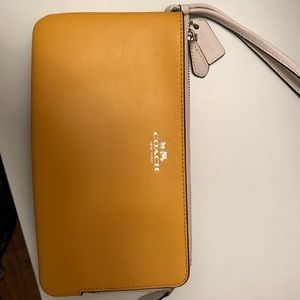 Yellow and tan C logo coach wristlet